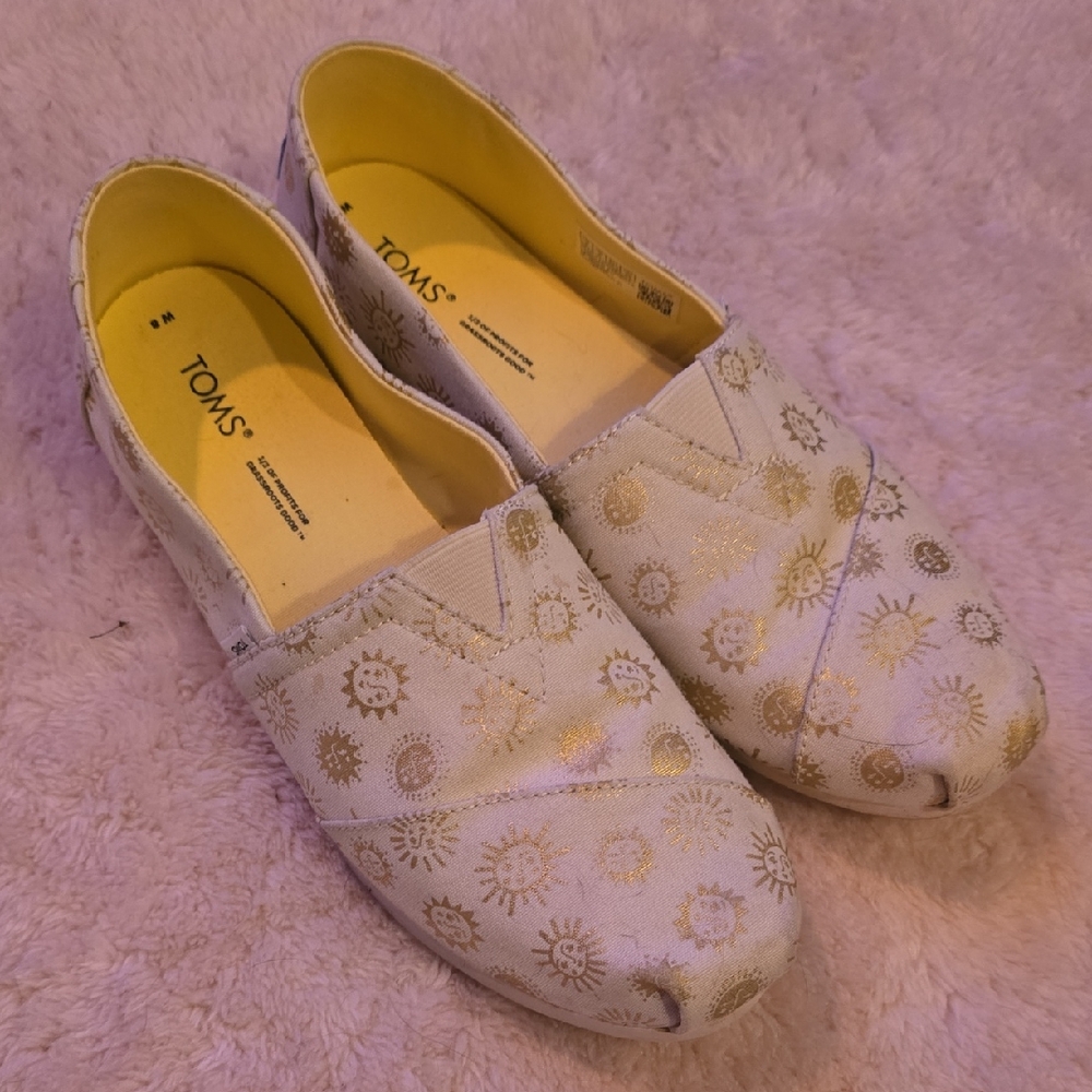 TOMS Beige and Gold Sunburst Slip-Ons